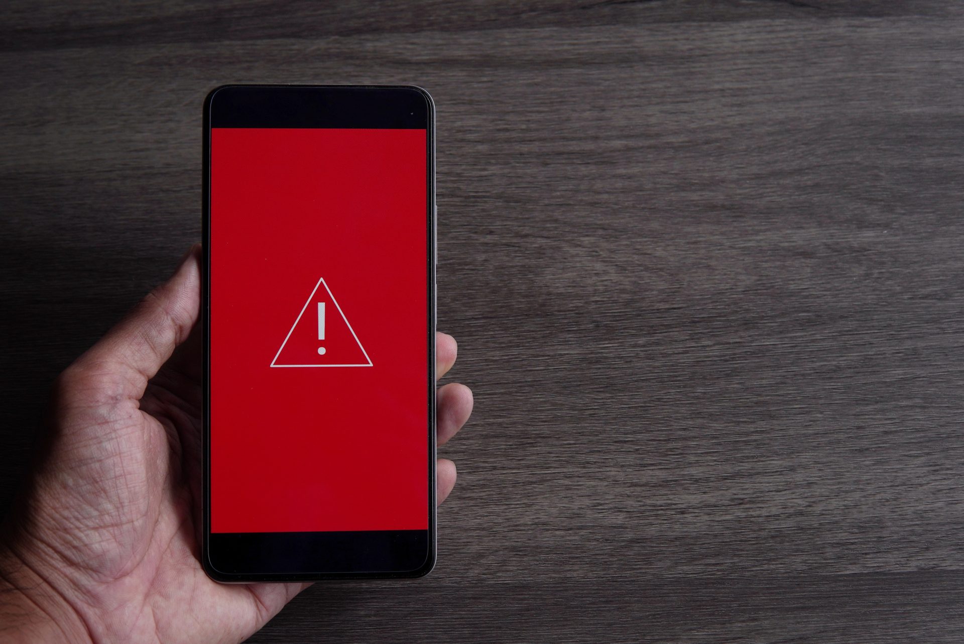smartphone with triangle caution warning icon 2023 11 27 18 53 40 utc 1